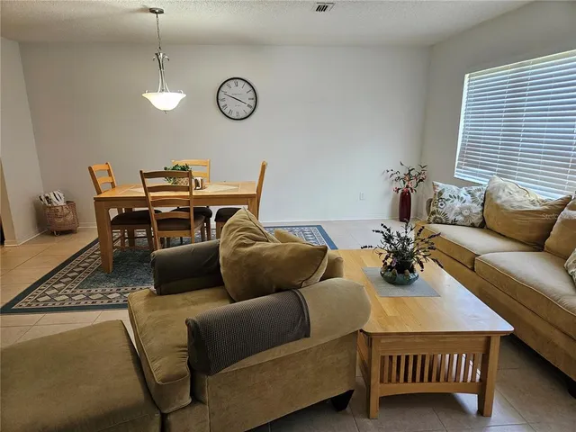a living room with furniture a rug and a window