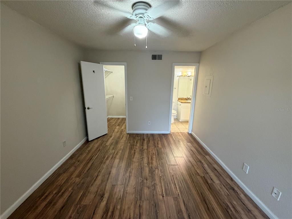 5128 Conroy Road, Unit 25 Orlando, FL 32811 - Photo 11 of 24 wooden floor in an empty room with a window