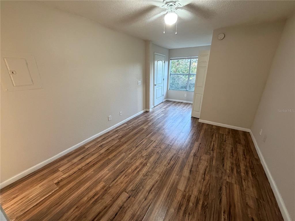 5128 Conroy Road, Unit 25 Orlando, FL 32811 - Photo 13 of 24 wooden floor in an empty room with a window