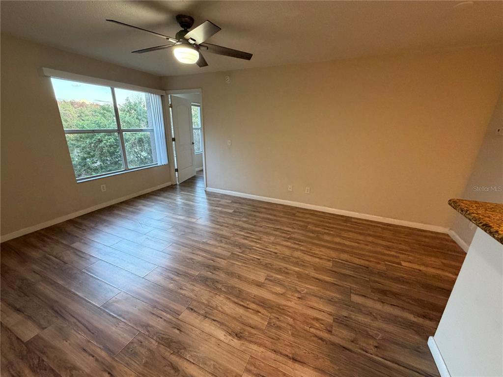 5128 Conroy Road, Unit 25 Orlando, FL 32811 - Photo 3 of 24 a view of an empty room with wooden floor and a window