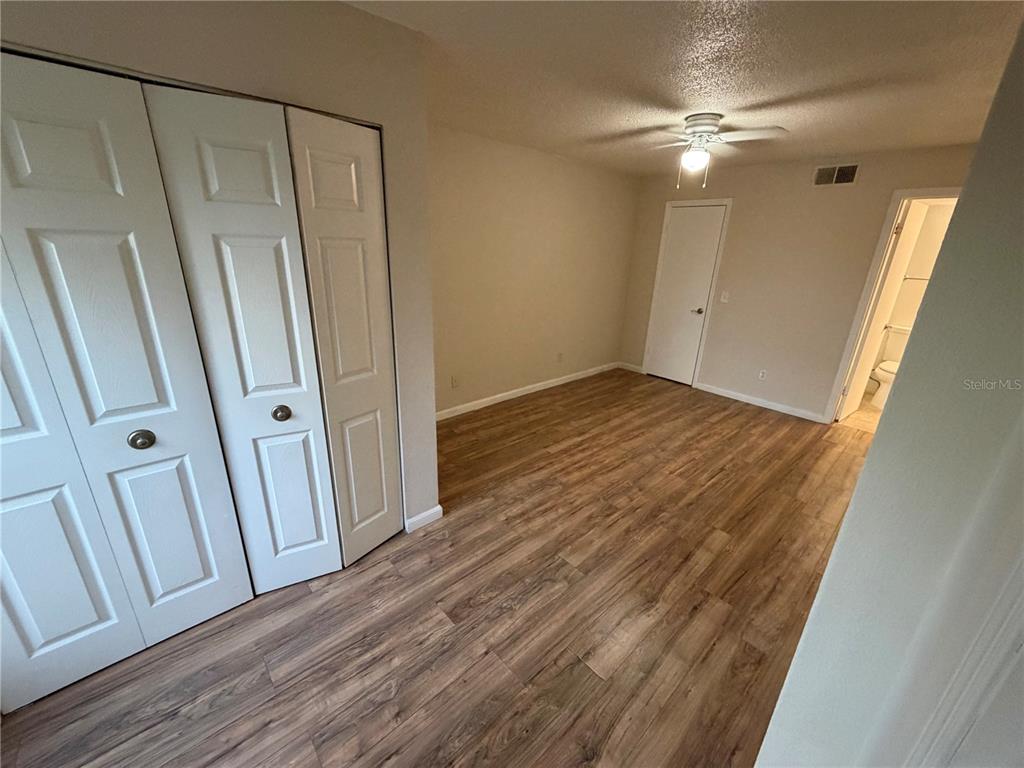 5128 Conroy Road, Unit 25 Orlando, FL 32811 - Photo 10 of 24 a view of a room with wooden floor and white walls