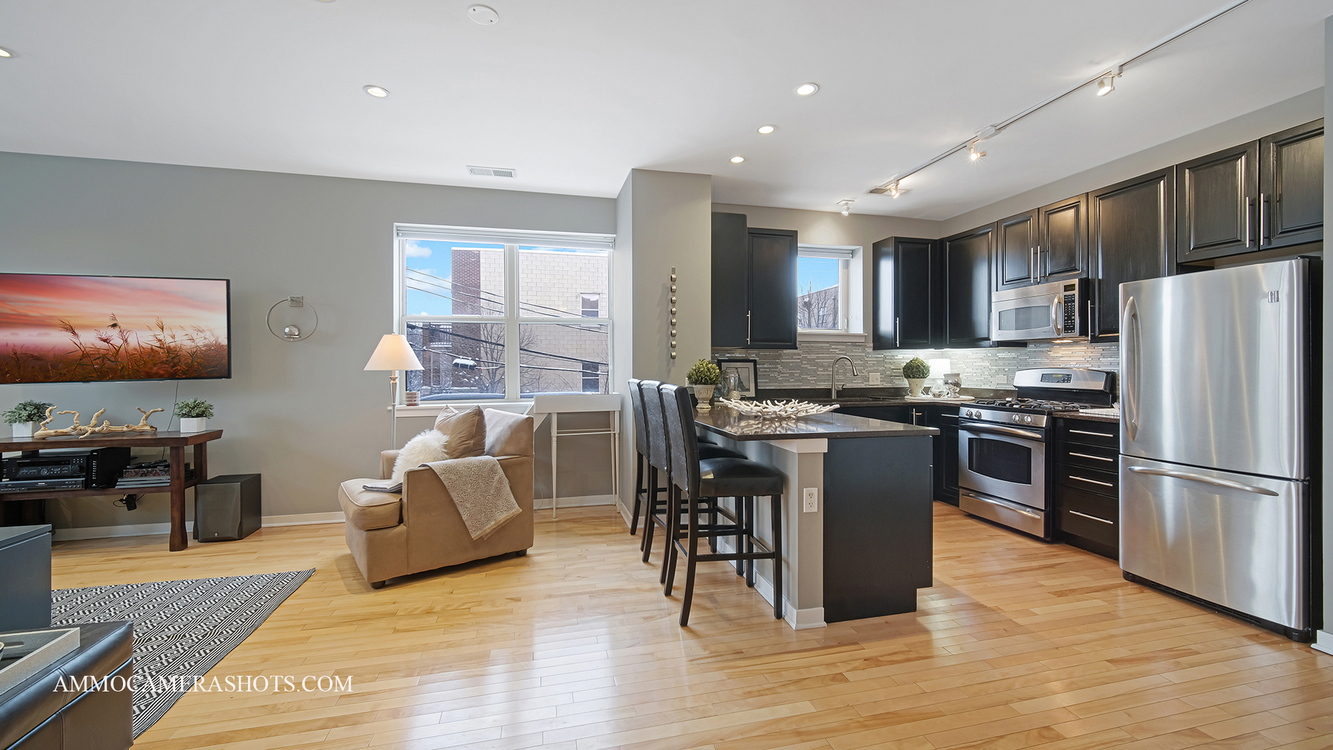 925 South Lytle Street, Unit A Chicago, IL 60607 - Photo 5 of 41 a kitchen with stainless steel appliances granite countertop a refrigerator stove microwave and sink