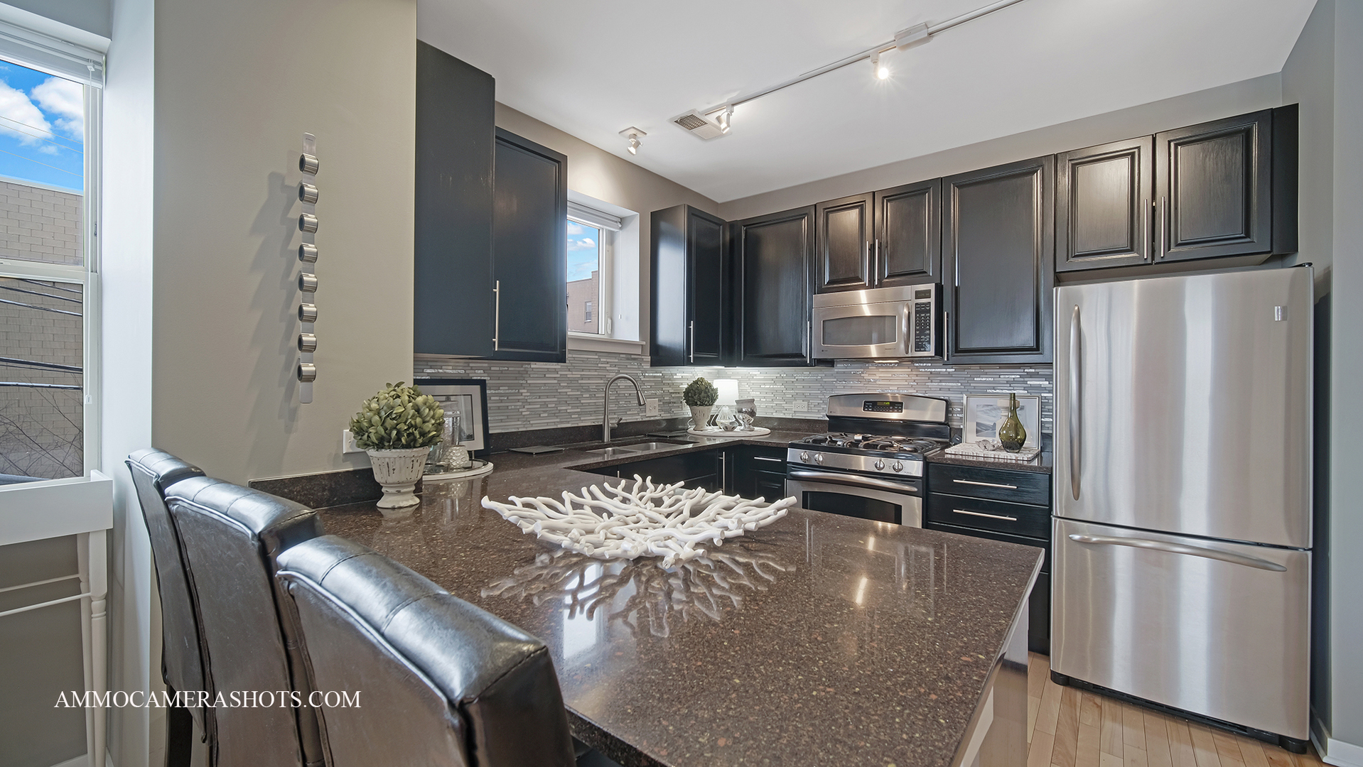 925 South Lytle Street, Unit A Chicago, IL 60607 - Photo 9 of 41 a kitchen with stainless steel appliances granite countertop a stove a refrigerator a sink dishwasher a dining table and chairs with wooden floor