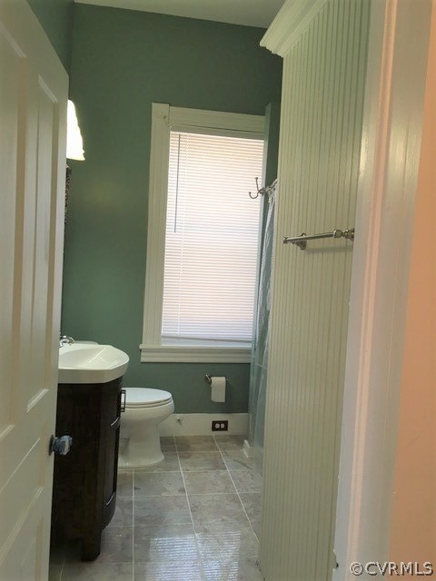 3038 Old Church Road Mechanicsville, VA 23111 - Photo 14 of 26 a bathroom with a sink a toilet and a mirror