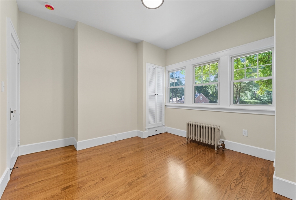 636 Amostown Road West Springfield, MA 01089 - Photo 20 of 40 a view of an empty room with wooden floor and a window