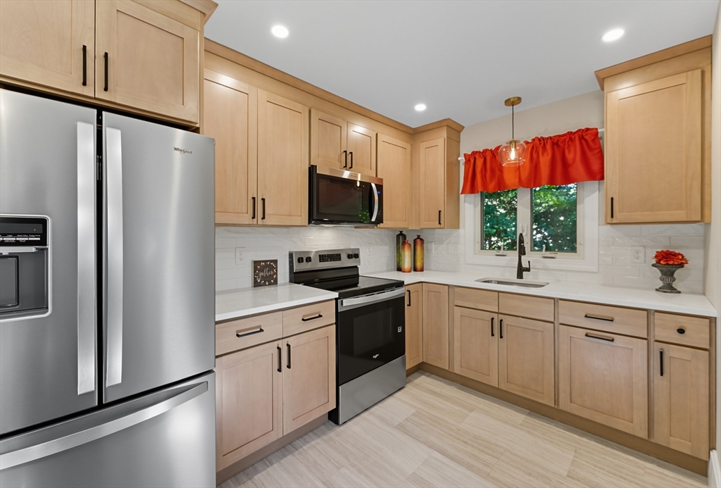 636 Amostown Road West Springfield, MA 01089 - Photo 2 of 40 a kitchen with a sink cabinets and stainless steel appliances