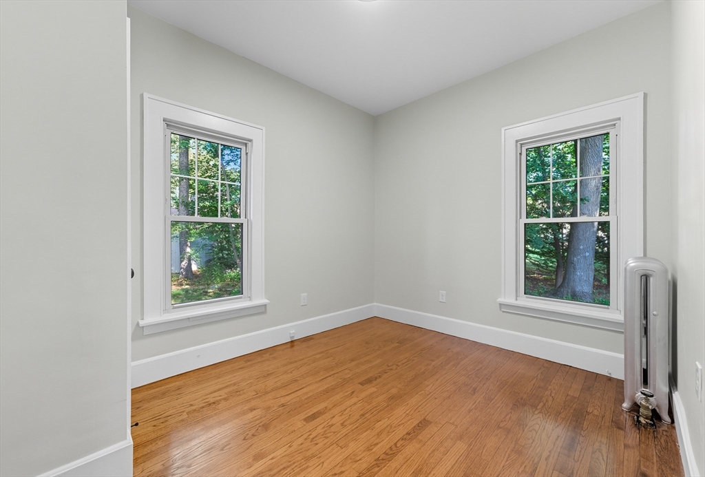 636 Amostown Road West Springfield, MA 01089 - Photo 22 of 40 an empty room with wooden floor and windows