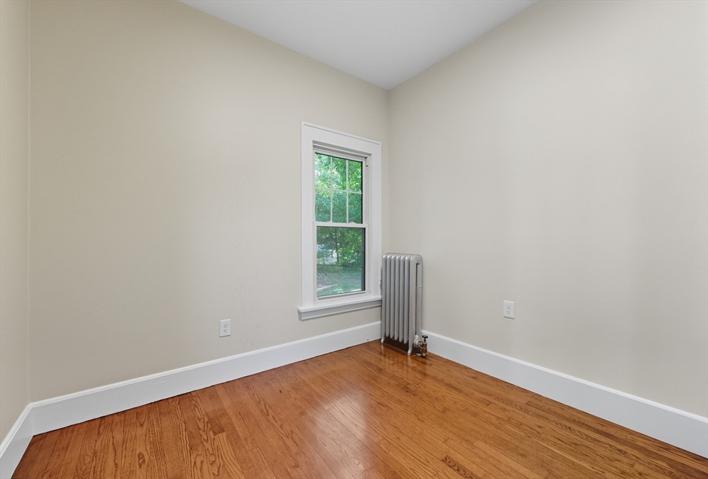 636 Amostown Road West Springfield, MA 01089 - Photo 25 of 40 a view of an empty room with wooden floor and a window
