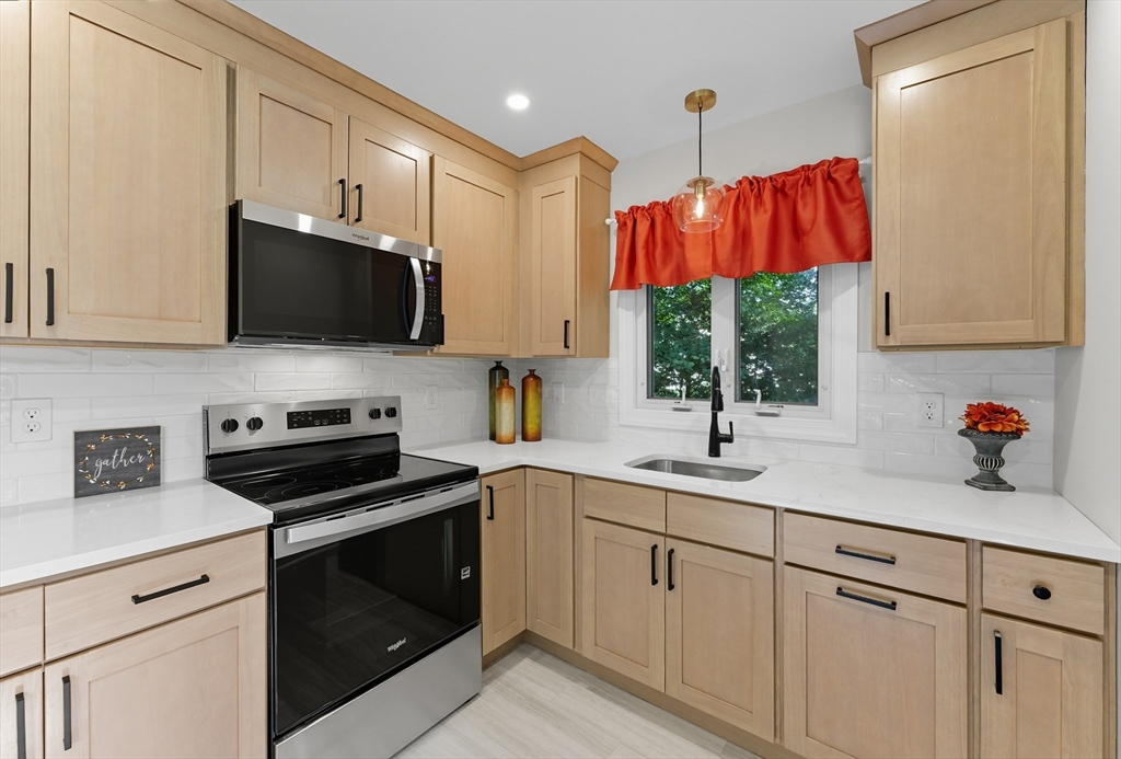 636 Amostown Road West Springfield, MA 01089 - Photo 3 of 40 a kitchen with stainless steel appliances white cabinets and a sink