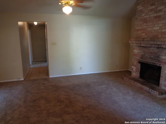 a view of an empty room with a fireplace
