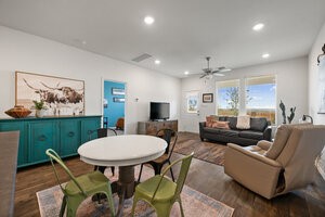 549 Arnold Loop, Unit A Kyle, TX 78640 - Photo 9 of 31 a living room with furniture kitchen view and a large window