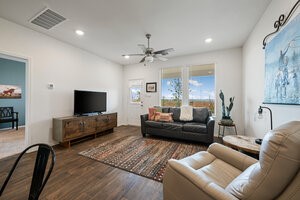 549 Arnold Loop, Unit A Kyle, TX 78640 - Photo 11 of 31 a living room with furniture and a flat screen tv
