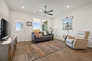 549 Arnold Loop, Unit A Kyle, TX 78640 - Photo 12 of 31 a living room with furniture and a flat screen tv