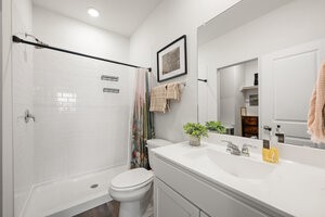 549 Arnold Loop, Unit A Kyle, TX 78640 - Photo 16 of 31 a bathroom with a sink a toilet and shower