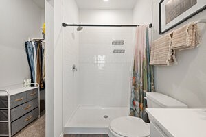 549 Arnold Loop, Unit A Kyle, TX 78640 - Photo 17 of 31 a bathroom with a sink toilet and shower