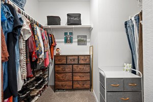 549 Arnold Loop, Unit A Kyle, TX 78640 - Photo 18 of 31 a view of walk in closet with clothes