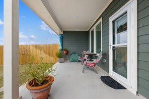 549 Arnold Loop, Unit A Kyle, TX 78640 - Photo 20 of 31 a building outdoor space with furniture and potted plants