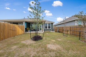 549 Arnold Loop, Unit A Kyle, TX 78640 - Photo 27 of 31 a backyard of a house with barbeque oven table and chairs