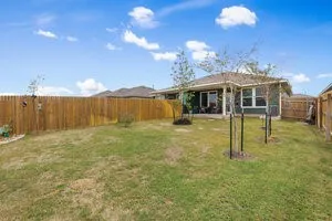 a backyard of a house with barbeque oven table and chairs