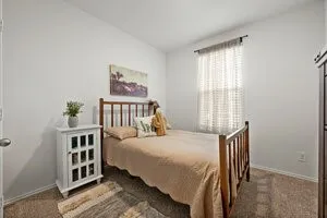 a bedroom with a bed and a window