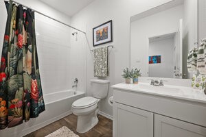549 Arnold Loop, Unit A Kyle, TX 78640 - Photo 5 of 31 a bathroom with a toilet sink and shower
