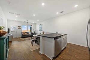 549 Arnold Loop, Unit A Kyle, TX 78640 - Photo 30 of 31 a kitchen with stainless steel appliances a table and chairs in it