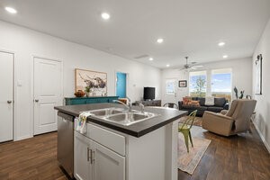 549 Arnold Loop, Unit A Kyle, TX 78640 - Photo 31 of 31 a living room with granite countertop furniture and a wooden floor