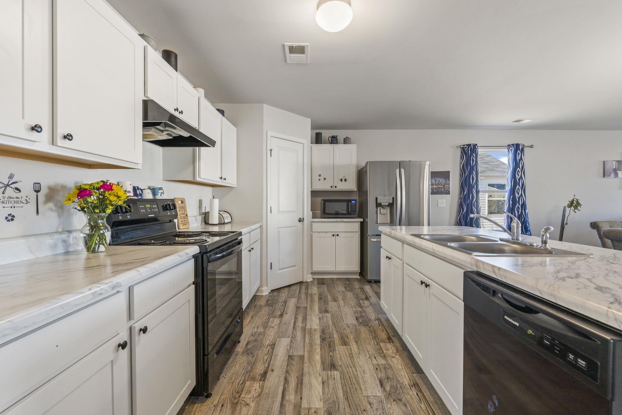520 Dundalk Drive Conway, SC 29526 - Photo 10 of 35 Kitchen featuring black appliances, under cabinet range hood, and white cabinetry