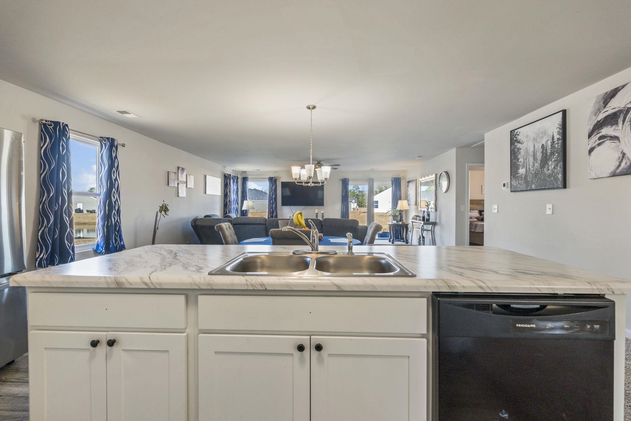 520 Dundalk Drive Conway, SC 29526 - Photo 34 of 35 Kitchen featuring white cabinets, black dishwasher, open floor plan, light countertops, and a chandelier