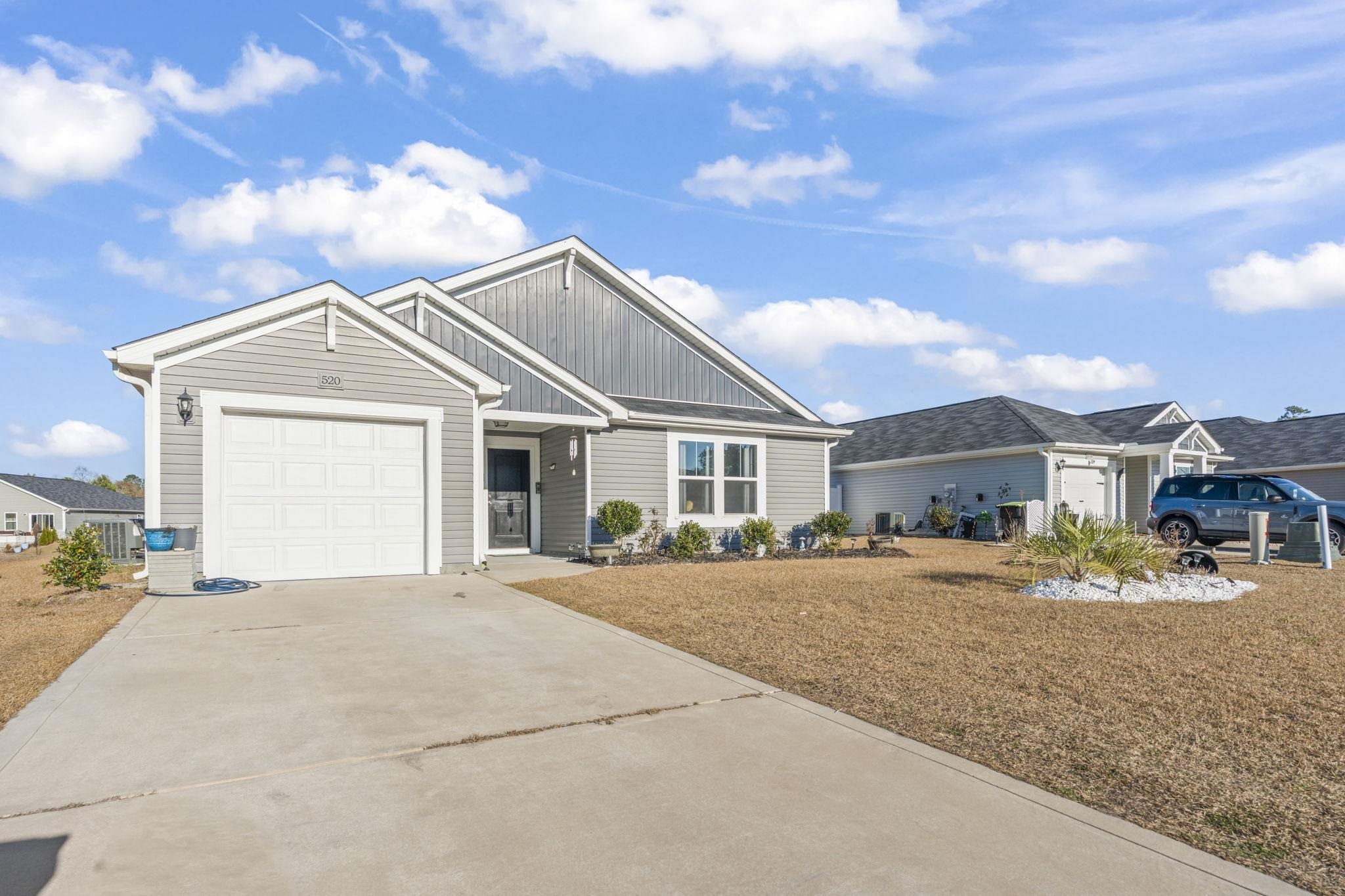 520 Dundalk Drive Conway, SC 29526 - Photo 32 of 35 View of front facade featuring board and batten siding, driveway, and an attached garage