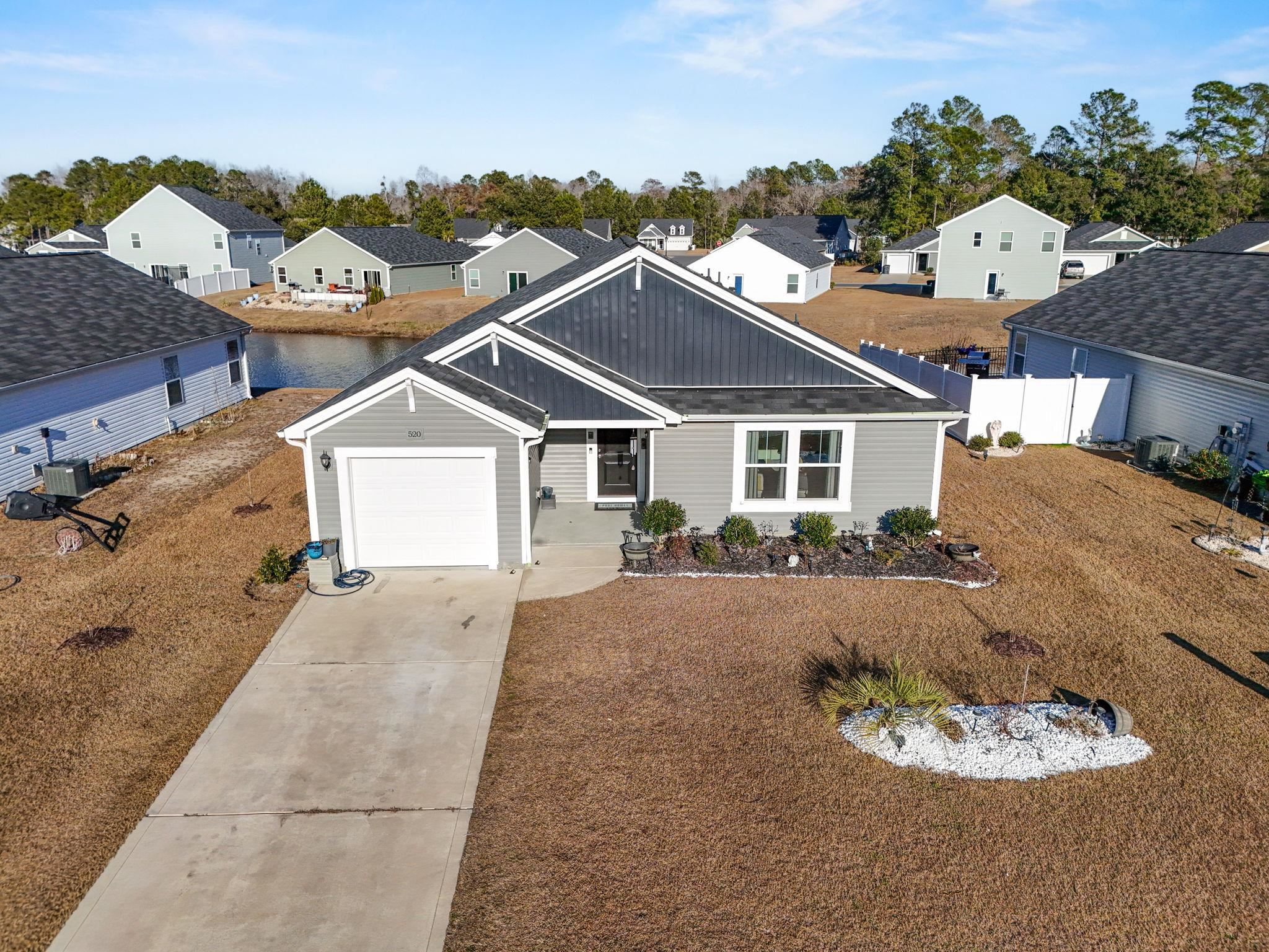 520 Dundalk Drive Conway, SC 29526 - Photo 5 of 35 View of front of property with concrete driveway, board and batten siding, a residential view, and a garage