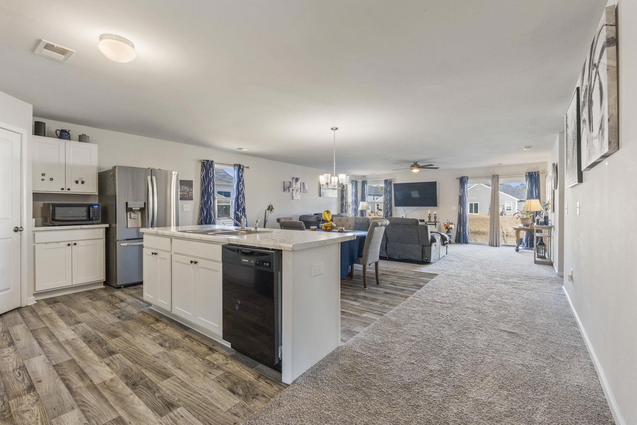 520 Dundalk Drive Conway, SC 29526 - Photo 33 of 35 Kitchen with a chandelier, open floor plan, a kitchen island with sink, black appliances, and decorative light fixtures