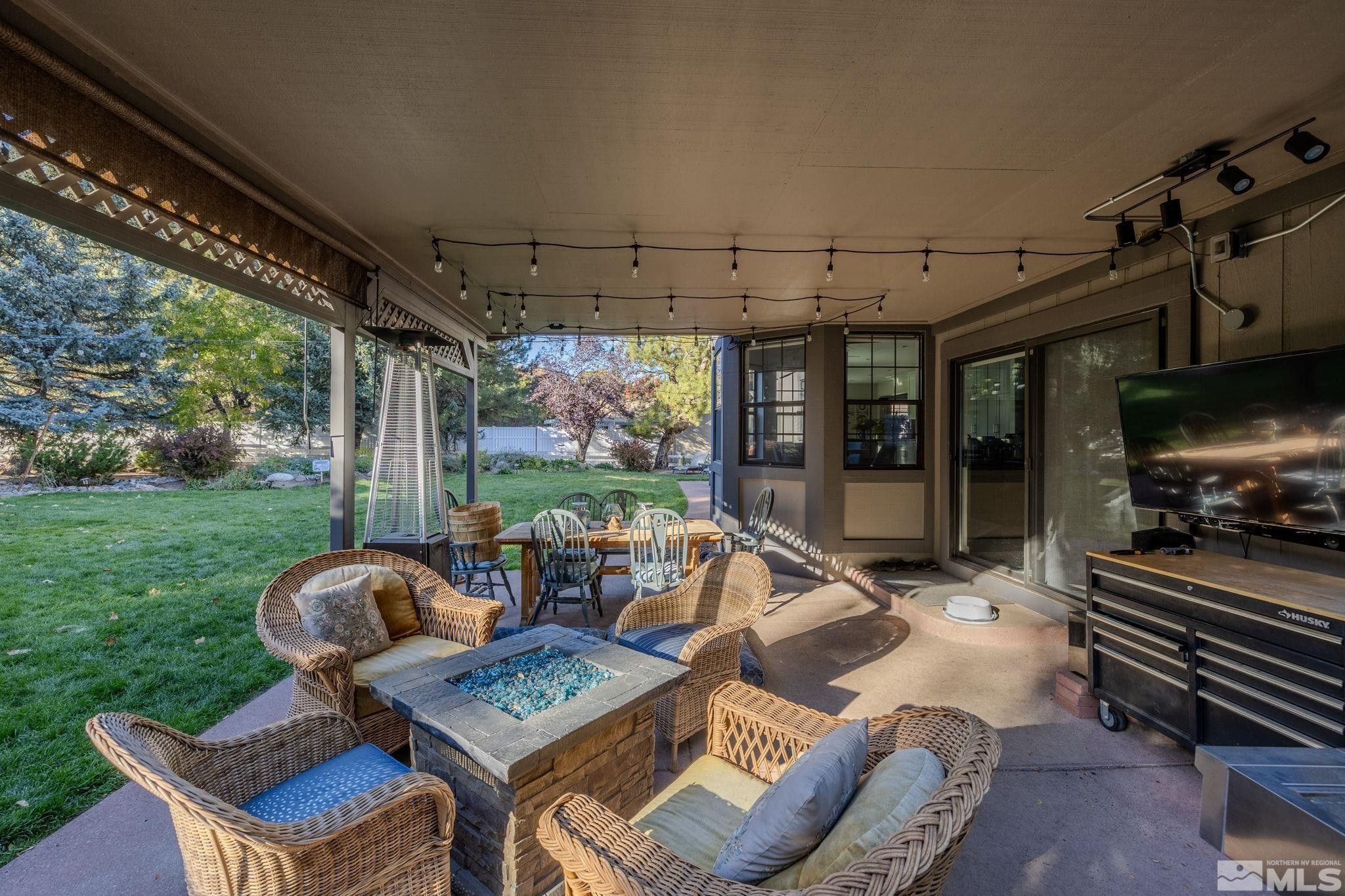 1075 Country Estates Circle Reno, NV 89511 - Photo 2 of 40 a view of a patio with table and chairs potted plants with floor to ceiling window