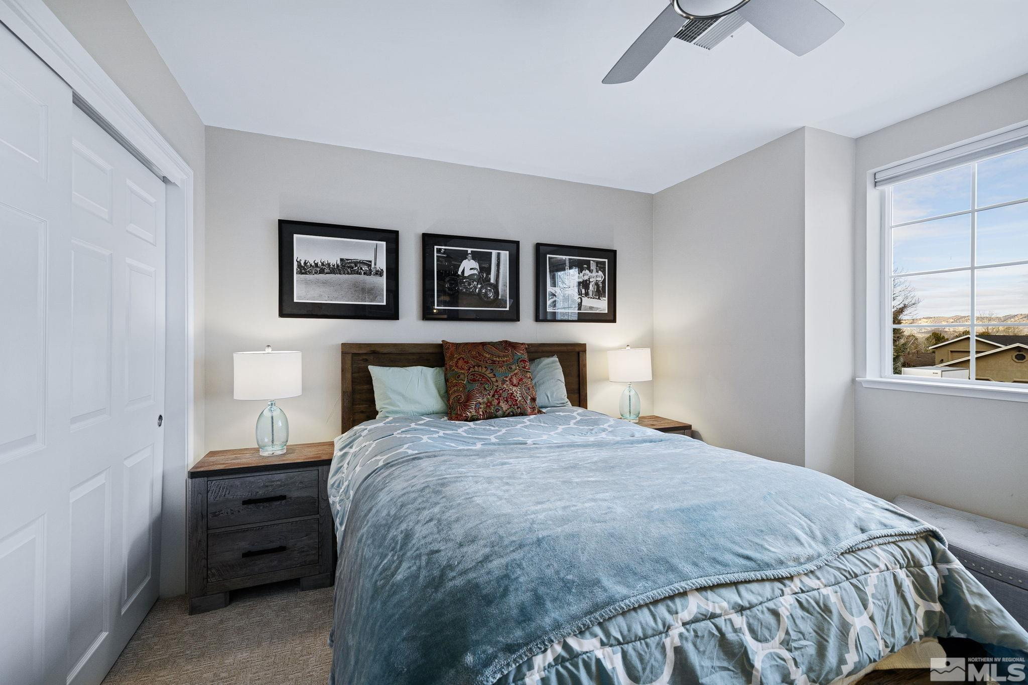 1075 Country Estates Circle Reno, NV 89511 - Photo 21 of 40 a bedroom with a bed and a window