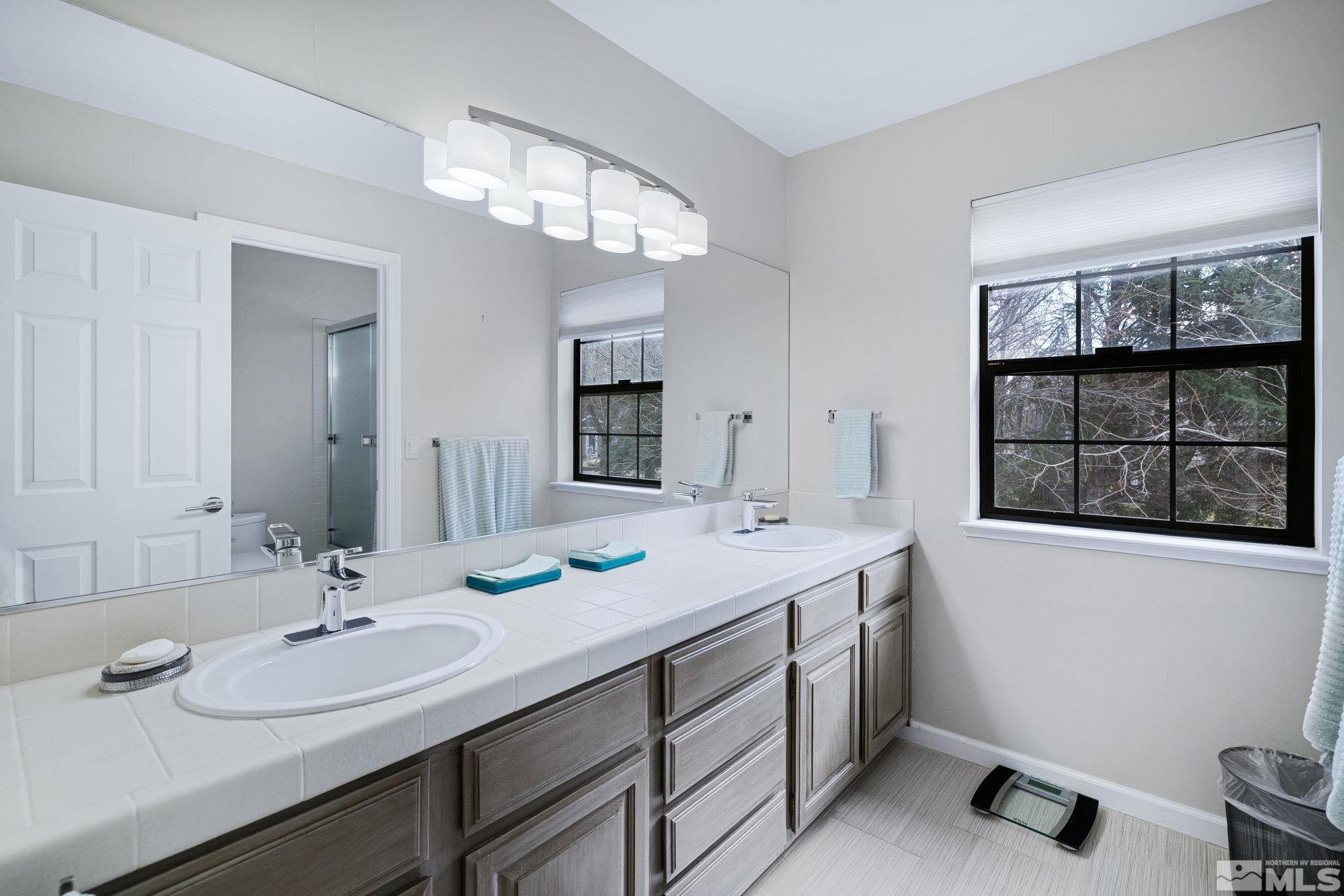 1075 Country Estates Circle Reno, NV 89511 - Photo 22 of 40 a bathroom with a sink double vanity and a mirror