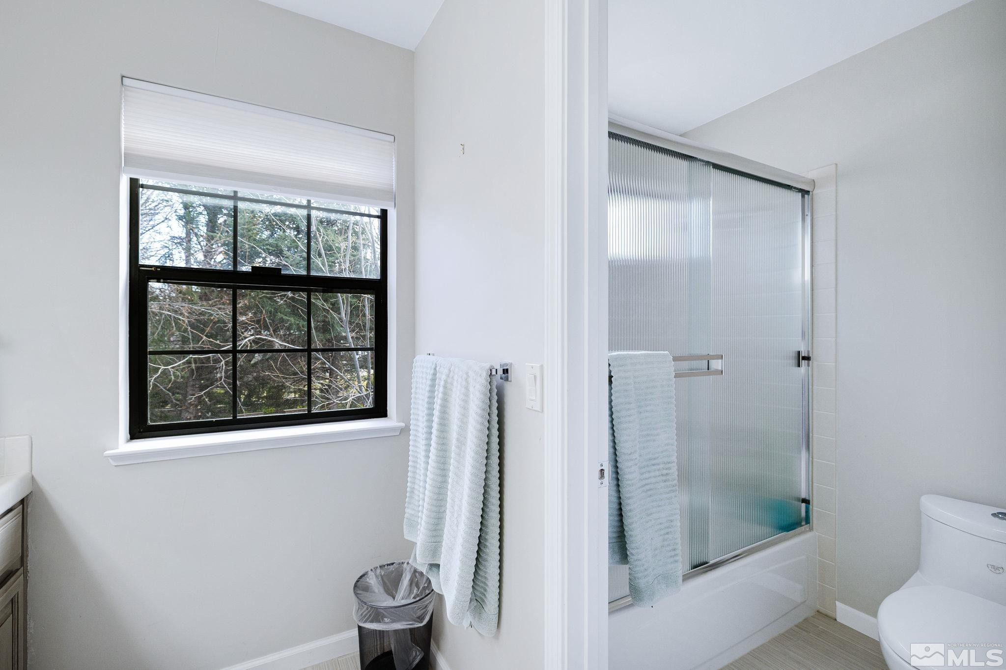 1075 Country Estates Circle Reno, NV 89511 - Photo 23 of 40 a bathroom with a shower and toilet