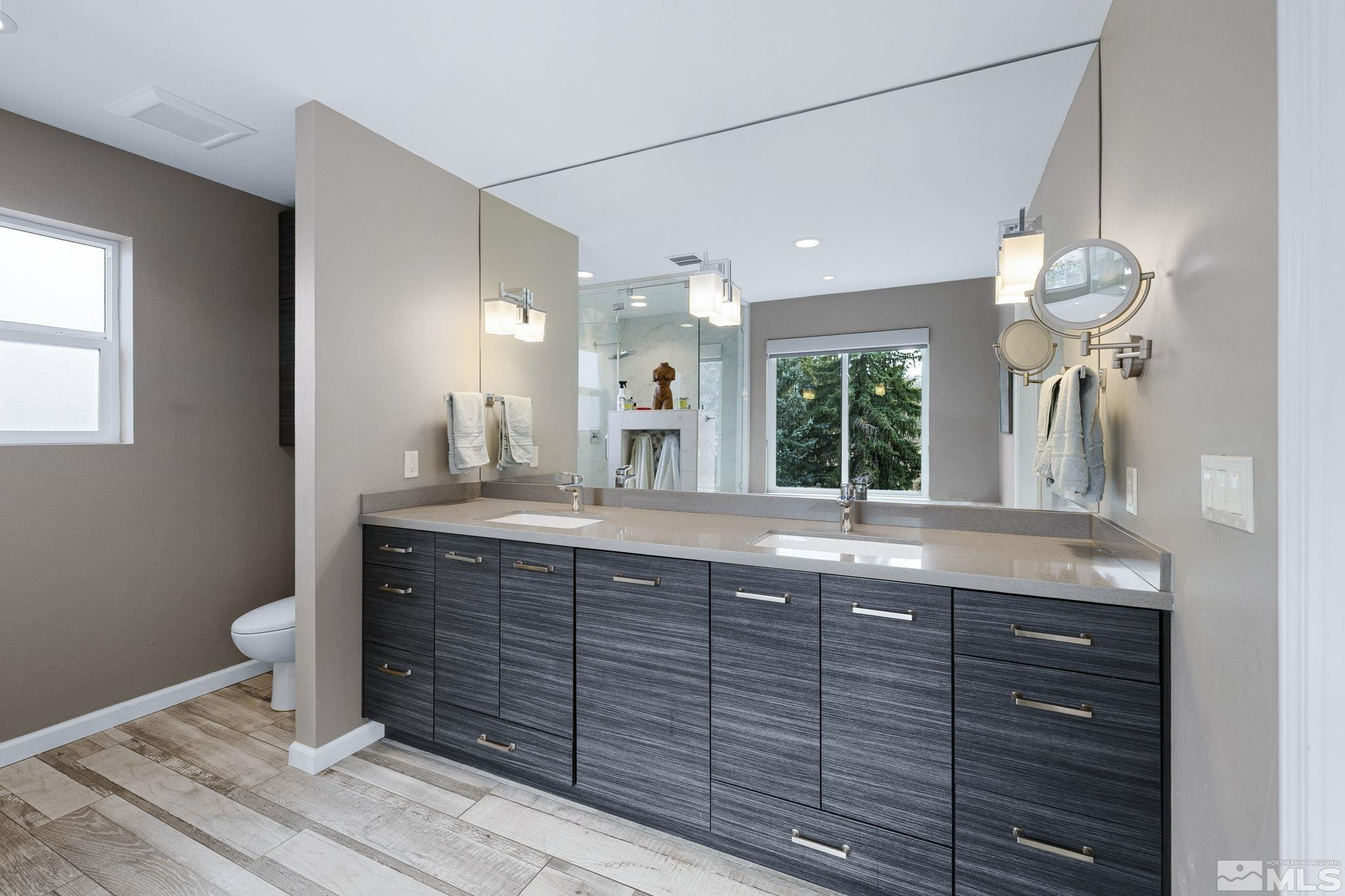 1075 Country Estates Circle Reno, NV 89511 - Photo 24 of 40 a bathroom with a granite countertop sink a toilet and a mirror