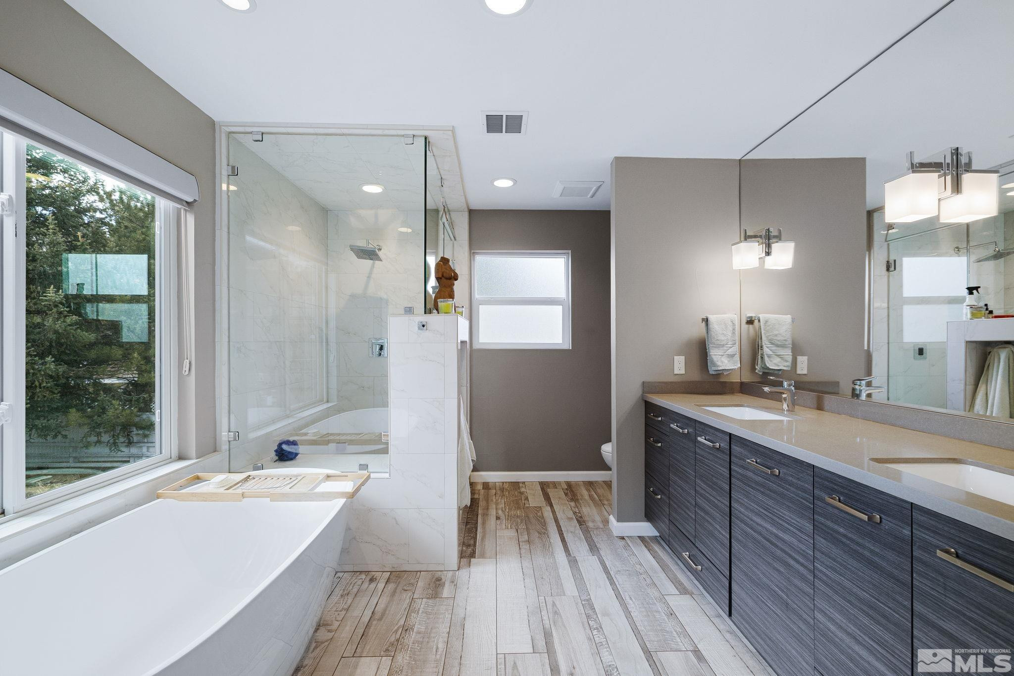 1075 Country Estates Circle Reno, NV 89511 - Photo 29 of 40 a bathroom with a tub sink shower and view