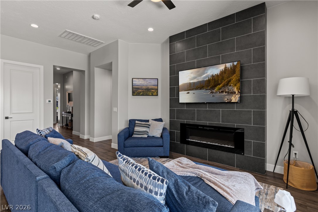 1436 Manassas Ridge Mesquite, NV 89027 - Photo 20 of 77 A striking tiled fireplace feature anchors this generously sized, well-lit living area.