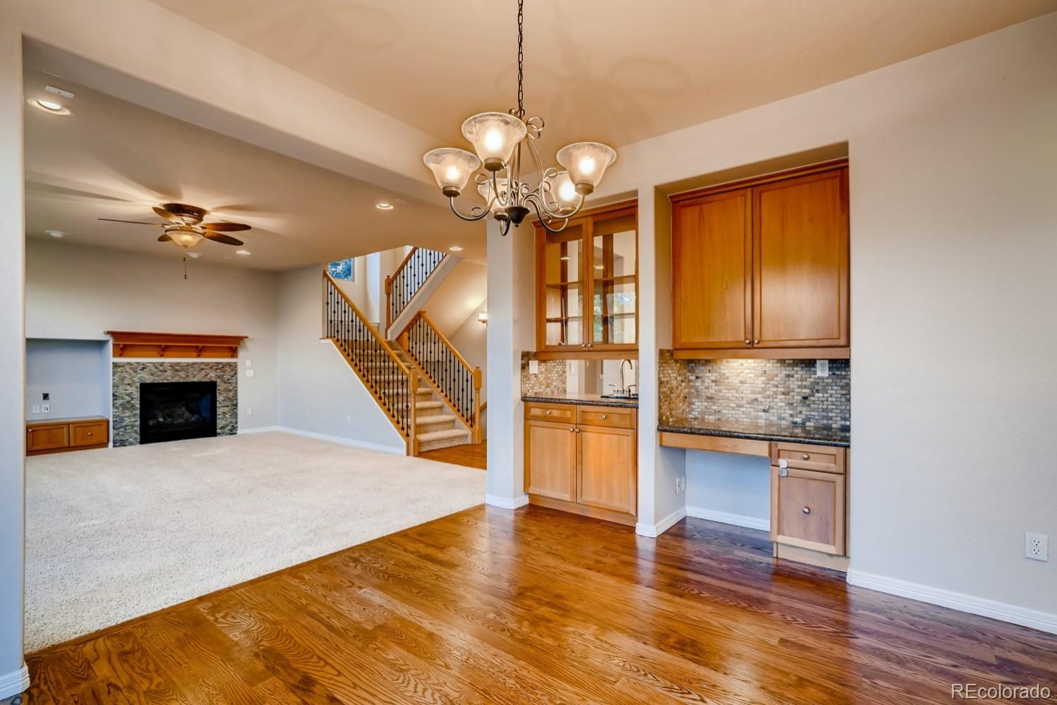 1644 Ridge Trail Lane Castle Rock, CO 80104 - Photo 12 of 38 a view of an empty room with wooden floor a fireplace and a window