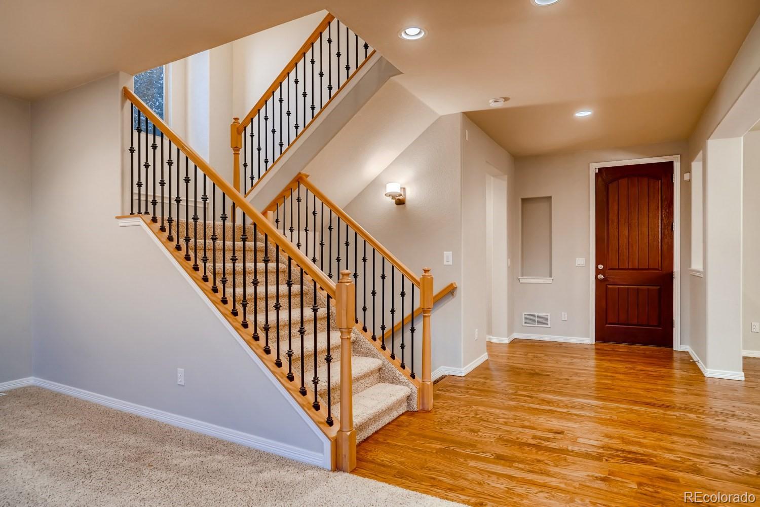 1644 Ridge Trail Lane Castle Rock, CO 80104 - Photo 16 of 38 a view of entryway and hall with wooden floor