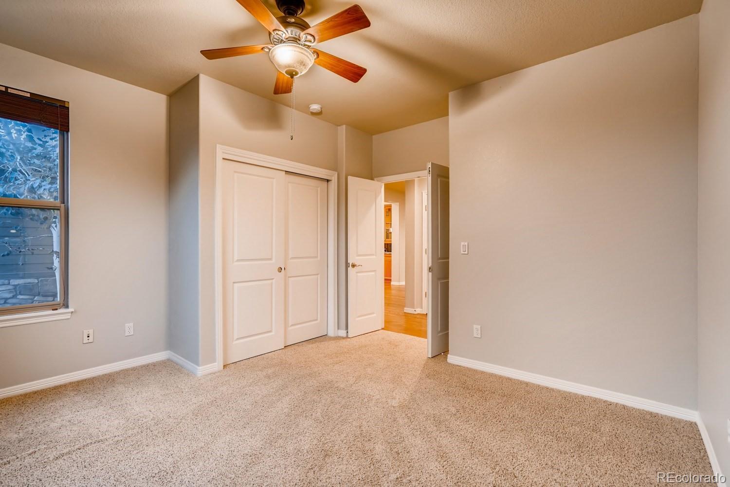 1644 Ridge Trail Lane Castle Rock, CO 80104 - Photo 19 of 38 a view of an empty room and window with a ceiling fan