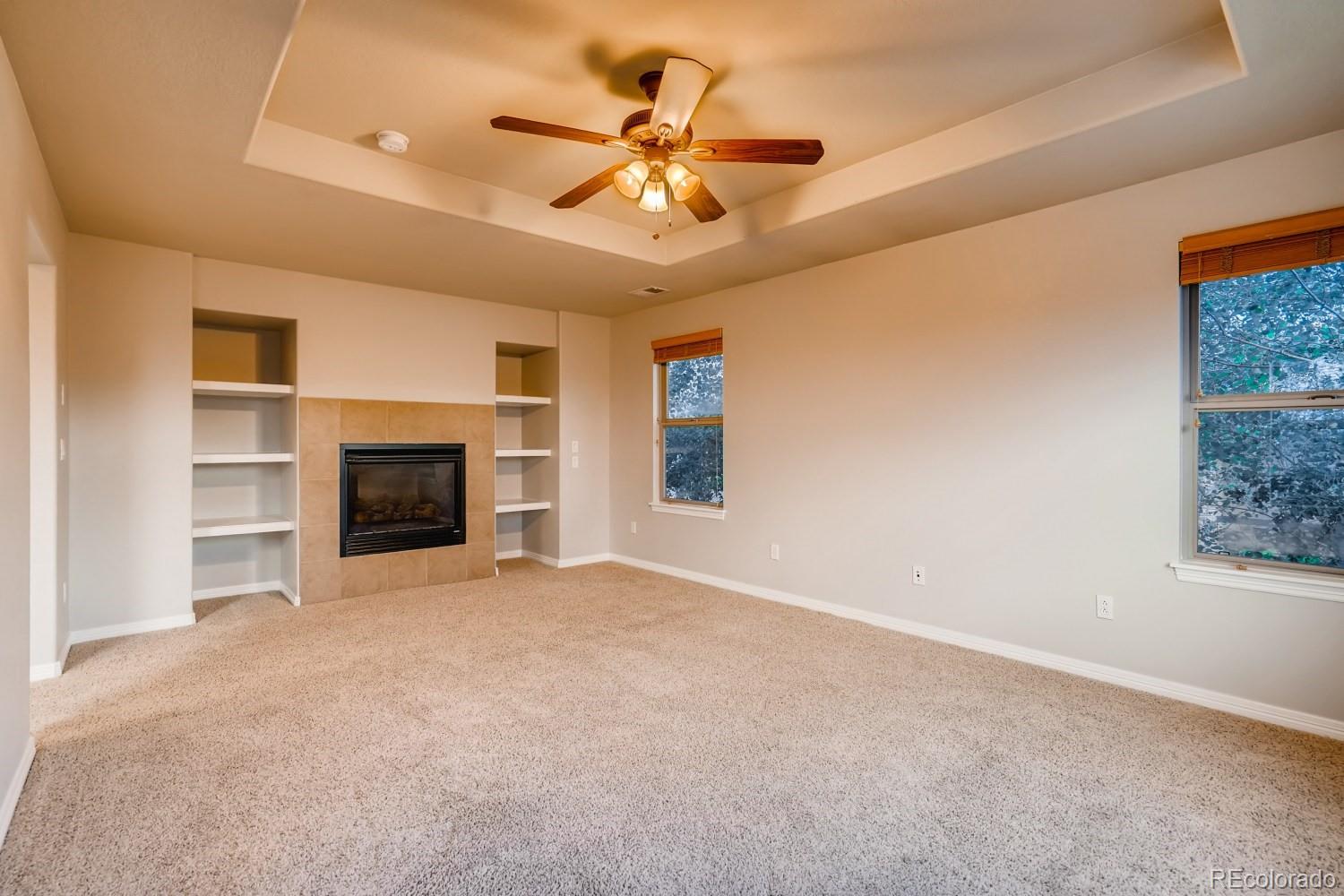 1644 Ridge Trail Lane Castle Rock, CO 80104 - Photo 21 of 38 an empty room with fireplace and fan