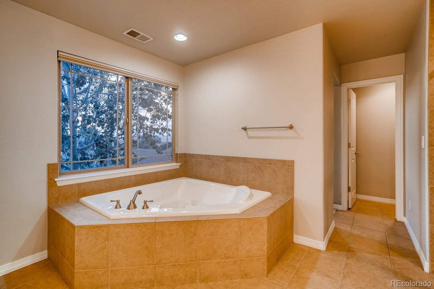 1644 Ridge Trail Lane Castle Rock, CO 80104 - Photo 23 of 38 a bathroom with a bathtub and window
