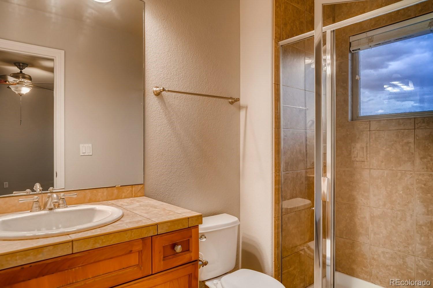 1644 Ridge Trail Lane Castle Rock, CO 80104 - Photo 27 of 38 a bathroom with a granite countertop sink and a mirror