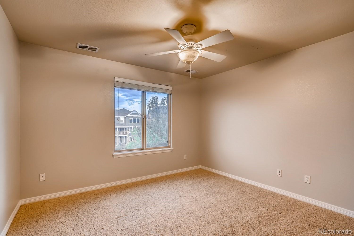 1644 Ridge Trail Lane Castle Rock, CO 80104 - Photo 28 of 38 an empty room with windows and fan