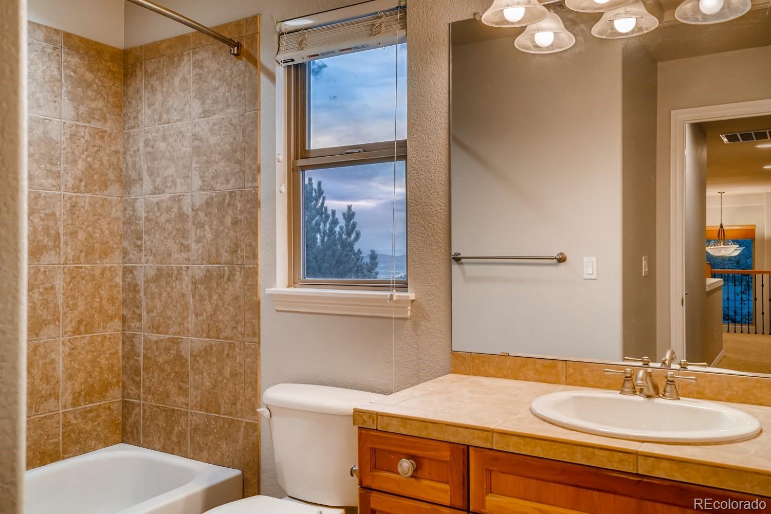 1644 Ridge Trail Lane Castle Rock, CO 80104 - Photo 30 of 38 a bathroom with a sink toilet and shower