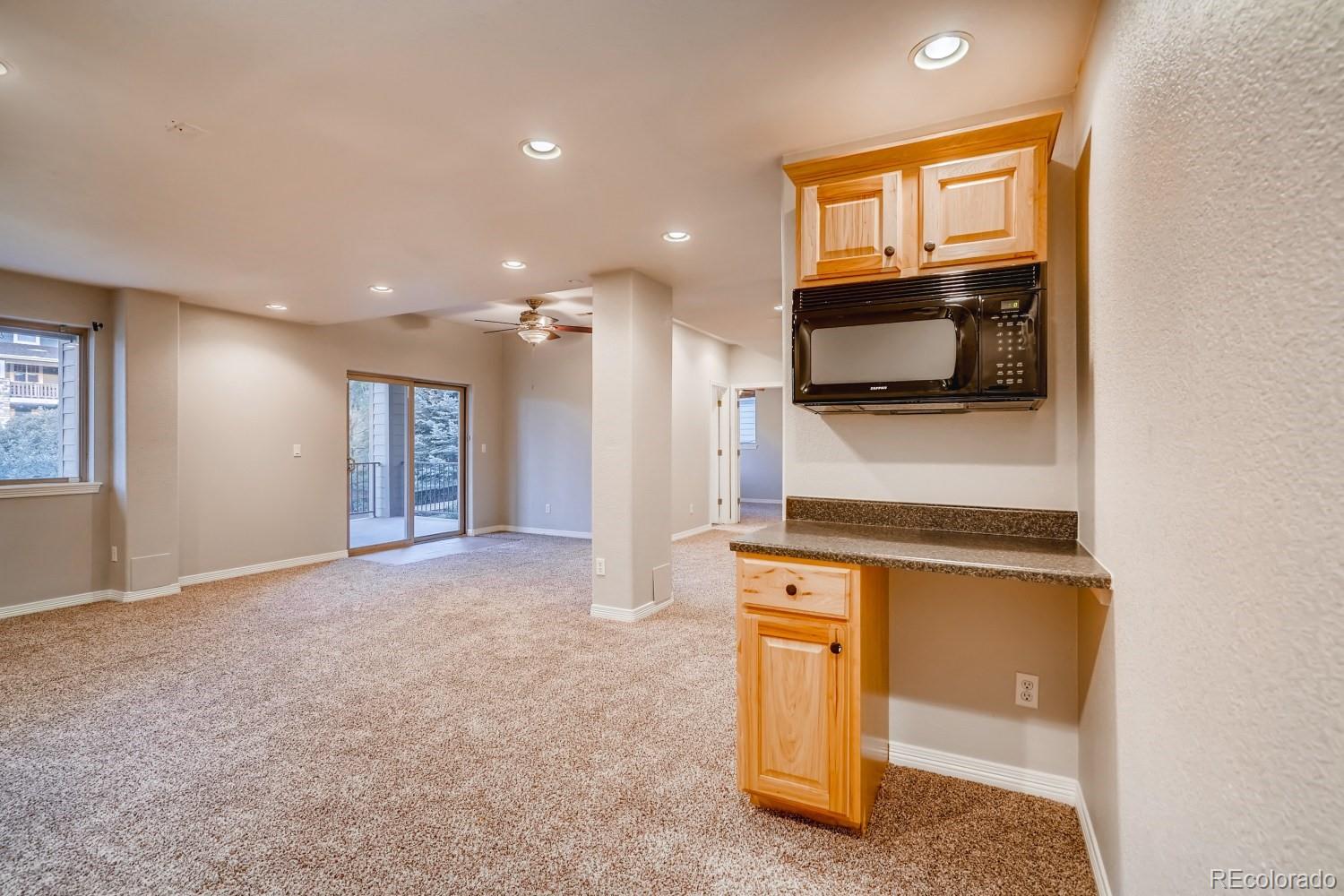 1644 Ridge Trail Lane Castle Rock, CO 80104 - Photo 32 of 38 a view of a kitchen with a sink a microwave and refrigerator