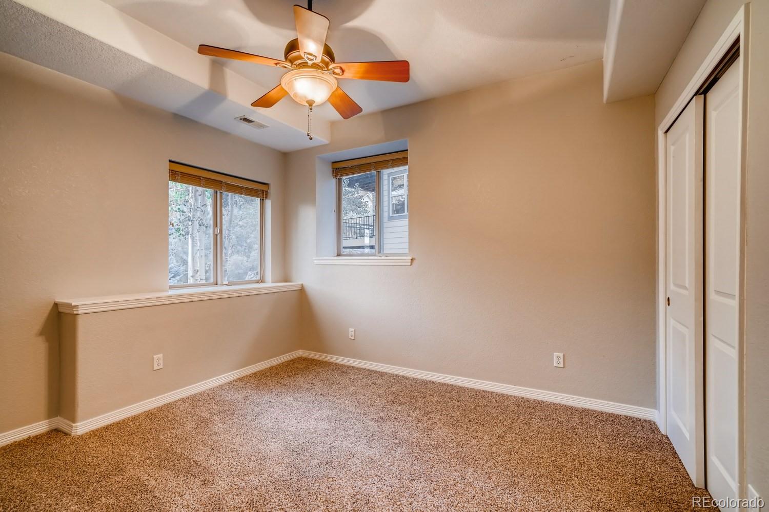 1644 Ridge Trail Lane Castle Rock, CO 80104 - Photo 35 of 38 an empty room with windows and fan