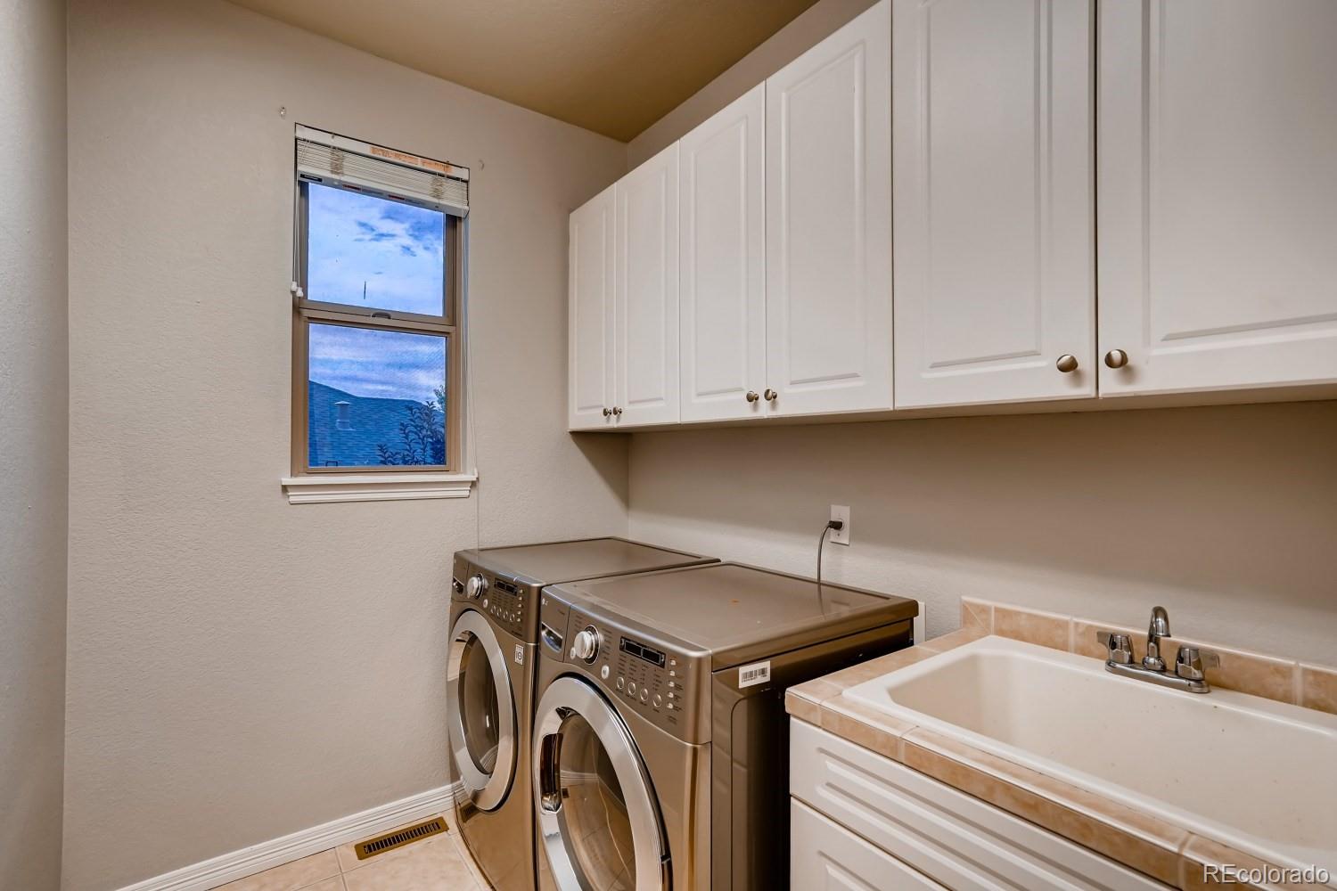 1644 Ridge Trail Lane Castle Rock, CO 80104 - Photo 7 of 38 a utility room with stainless steel appliances washer and dryer